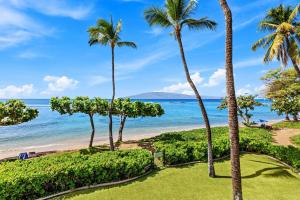 a view of the beach and palm trees at Puunoa Beach Estates 205 in Lahaina