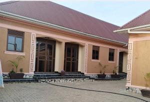 ein Gebäude mit einem roten Dach und einem Innenhof in der Unterkunft OnlineGuest House Katete in Mbarara