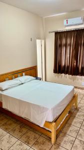 a bedroom with a large bed in a room at Hotel Nacional Service in Goiânia +11 photos