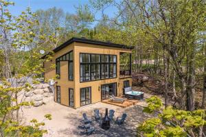 an aerial view of a tiny house in the woods at Chalet Le Greenwood - Mountain View & Private Spa in Saint-Faustin