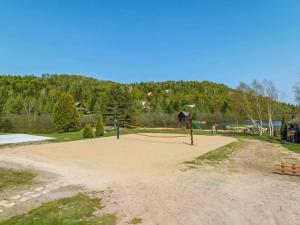 a playground with a volley ball net in a park at Chalet Le Greenwood - Mountain View & Private Spa in Saint-Faustin +20 photos