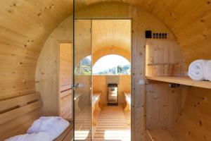 a room in a tree house with a glass door at Weingut Gasshof- Panorama Pool in den Weinbergen in Appiano sulla Strada del Vino +54 photos