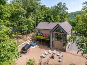 an overhead view of a house with chairs and a grill at Le Greenwood 2 - Sauna - Spa - Mountain View in Saint-Faustin