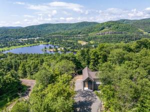 an aerial view of a house with a view of a lake at Le Greenwood 2 - Sauna - Spa - Mountain View in Saint-Faustin +22 photos