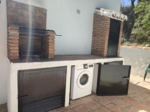 a washer and dryer sitting on a patio at Casa Cuesta Gato in Sedella