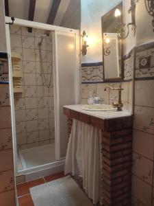 a bathroom with a sink and a shower at Casa Cuesta Gato in Sedella +20 photos