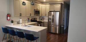 a kitchen with a sink and a refrigerator at Attractive and Cozy Apartment - 4 bdrms 2 bths in Paterson