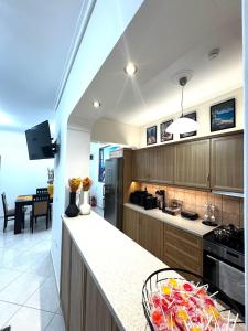 a kitchen with a counter with a bowl of fruit at Blue Port Beach House in Rafina