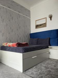 a bedroom with a bed with a blue accent wall at Studio tres calme Quartier administratif Rabat in Rabat +13 photos
