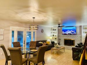 a living room with a table and a couch at Tempe Escape with Heated Pool, Billiards & Firepit Fun in Tempe