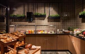 a kitchen with a bunch of different types of food at Hotel Indigo Berlin - East Side Gallery by IHG in Berlin +132 photos