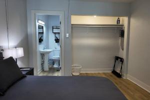 een slaapkamer met een bed en een badkamer met een wastafel bij The Belmont at PWC in Hot Springs +5 foto's