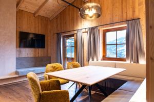 a dining room with a table and chairs at Schulhaus Tirol in Zell am Ziller