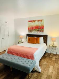 a bedroom with a bed with a bench in it at Tempe Escape with Heated Pool, Billiards & Firepit Fun in Tempe +25 photos