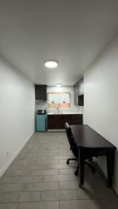 an empty room with a table and a kitchen at Florentine Motel And Studio in Bell