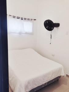 a white bedroom with a bed and a window at Nuestras raíces 1 in Villa Carlos Paz +15 photos