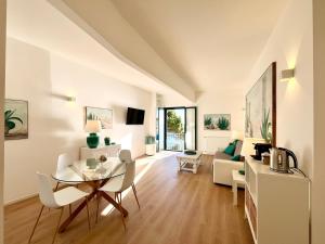a dining room and living room with a table and chairs at Mimosa Seafront Apartment - Free parking Wi-Fi in Varazze