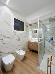a bathroom with a toilet and a sink and a shower at Mimosa Seafront Apartment - Free parking Wi-Fi in Varazze +29 photos