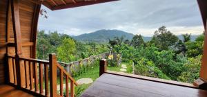 a balcony of a house with a view of a forest at Kastawa Villa in Sidemen