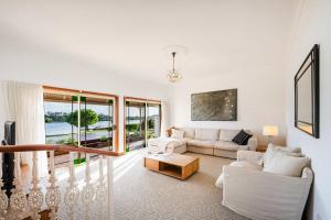 a living room with a couch and a table at Crystal Palms - Oceanstays - Riverside in Yamba