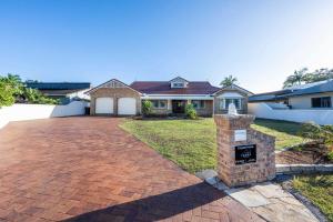 a brick driveway in front of a house at Crystal Palms - Oceanstays - Riverside in Yamba