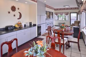 a kitchen and dining room with a table and chairs at Americas Best Value Inn Wildersville in Wildersville