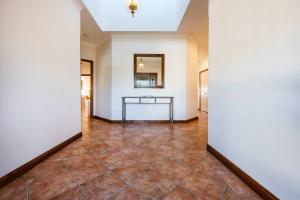 a hallway with a table in the middle of a room at Crystal Palms - Oceanstays - Riverside in Yamba +41 photos