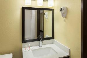 a bathroom with a sink and a mirror at Super 8 by Wyndham Marietta in Marietta +23 photos