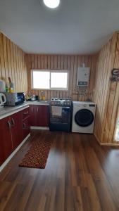 a kitchen with a stove and a dishwasher at Casa en Puerto Montt in Puerto Montt