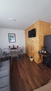 a living room with a table and a television at Casa en Puerto Montt in Puerto Montt