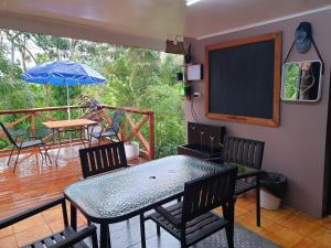 un patio con tavolo, sedie e ombrellone di Master's Homestay a Suva