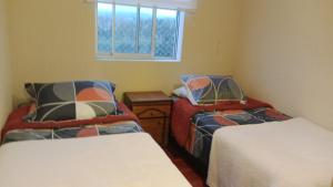 Giường trong phòng chung tại Condominio Laguna Vista Algarrobo