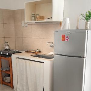 a kitchen with a sink and a refrigerator at Kalma in Villa Elisa