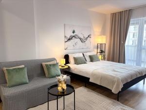 a living room with a bed and a couch at LUMO Terrace Studio with Private Parking near Coresi in Braşov