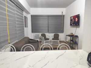 a living room with a couch and chairs at Apartment on Margarita Island edif Lagunablanca Apto 1201 in Porlamar