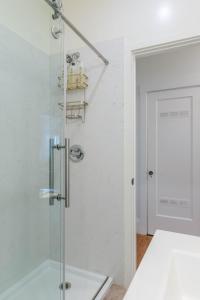 a shower with a glass door in a bathroom at 4 Berkeley Furnished Apartment - 2 Beds Laundry and Parking in Berkeley +19 photos