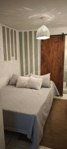 a bedroom with a bed and a chandelier at Casa Rio in Cruz del Eje