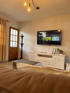 a bedroom with a large tv on the wall at Rosa Mosqueta Esquel in Esquel