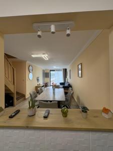 a living room with a table and a couch at Famenne Escape in Marche-en-Famenne