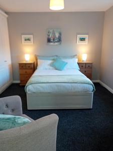 a bedroom with a large bed with two night stands at Luxurious Double En-Suite Tralee Town Centre in Tralee