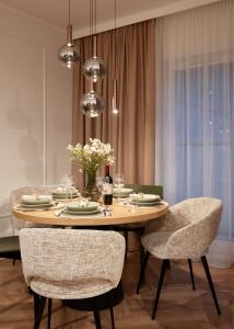 a dining room table with two chairs and a dining room table at Apartament Hugo - Stare Miasto - Garaż Gratis !!! in Elblag +9 photos