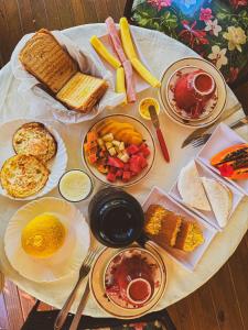 a table with many different types of food on it at Aruana Suites com Cafe da manha,Piscina, Reserva Natural da Sapiranga 5km da Vila de Praia do Forte in Castelo da Tôrre
