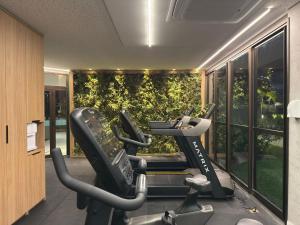 a gym with treadmills and ellipticals in a building at Beach Class Summer Residence in Porto De Galinhas