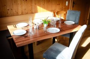 a wooden table with four chairs and a wooden tableablish at Schlickhütte in Grossarl +8 photos