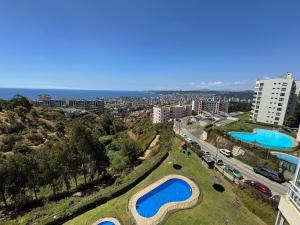 eine Luftaufnahme einer Stadt mit zwei Schwimmbädern in der Unterkunft Excellent apartment, view and quiet atmosphere in Viña del Mar