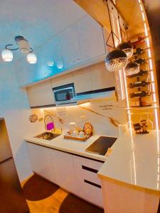 a kitchen with white cabinets and a counter top at MD Suite by Seawind in Davao City