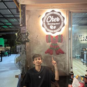 a man standing in front of a sign with a bow tie at cher lonely beach resort Koh chang in Ko Chang +23 photos