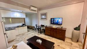 a living room with a kitchen and a table at Nattaya at the Jayakarta Bali in Seminyak