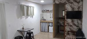 a small kitchen with a small table in a room at Micasa in Chuy