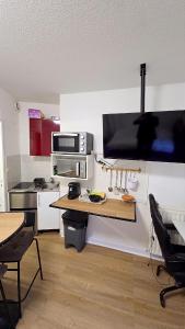 a small kitchen with a table and a microwave at Studio Antigone centre ville in Montpellier